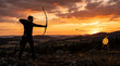 © galam - Silhouette of an archer shooting an arrow at a target during sunset over a mountainous landscape