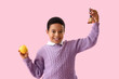 © Pixel-Shot - Little African-American schoolboy with bell and apple on pink background