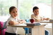 © Pixel-Shot - Little students sitting at desks in classroom