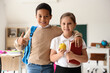 © Pixel-Shot - Little students with apple and book in classroom