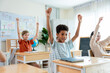 © Kawee - Group of diverse students celebrating first day of learning at primary school.