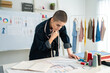 © Kawee - Caucasian young woman working as fashion designer in tailor studio.