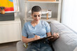 © Kawee - Caucasian woman with shaved head hairstyle drawing artwork at home studio.