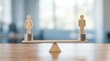 © SunSpirit - Wooden figures of a woman and man on balanced scales representing pay equity and wage fairness.