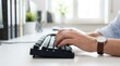 © pakawan - Hands of a volunteer typing on a desktop computer for secure recordkeeping, with a soft blur in the background.