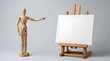 © Mehbubakhatun - A wooden artist mannequin gesturing toward a blank white canvas on a wooden easel in a studio