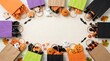 © ROKEYA - Top view of colorful halloween gift bags with candy and spooky decorations halloween decorations celebration colorful creative packaging handmade seasonal arrangement background overhead