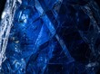 © tsarhadi - Raw sapphire fills the frame with vivid deep electric blue in dramatic sidelight — the most precious blue stone as ultimate fine art. Ideal for luxury, jewelry, and premium design backgrounds.