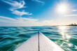© Anastasiia - A white surfboard points toward the bright sun over a vast blue ocean under a clear sky.