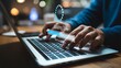 ©  TOFEL - Programmer types on a laptop while a system update is loading.