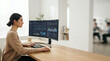 © EchoFrame - Woman at desk with curved monitor displaying analytics