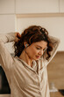 © La Famiglia - Woman with hearing aid getting ready in kitchen