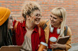 © La Famiglia - Diverse students laughing together enjoying campus friendship