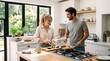 © creativestock - Happy couple preparing breakfast together in a bright modern kitchen with large windows overlooking a garden