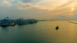 © Amazing Aerial - Aerial view of MPS Terminal 3 at the Port of Accra with large container ships docked by gantry cranes under a golden sunset sky in Accra, Greater Accra, Ghana.