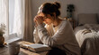 © Yelyzaveta - Young Christian woman praying over an open Bible beside her bedroom window, peaceful morning devotion, faith and spiritual reflection at home.