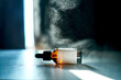© Marevgenna - Amber dropper bottle resting with a mist creating bokeh