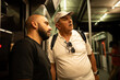 © Nazareno - Two men commuting in crowded subway car