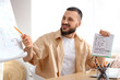 © Pixel-Shot - Smiling young man teaching arabic language Online, pointing at a whiteboard with a pencil and holding a notebook