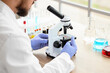 © Pixel-Shot - Male scientist with microscope working in laboratory, closeup