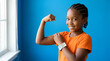 © Madi - Young girl flexing bicep wearing health tracking wristband.