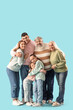 © Pixel-Shot - Big family hugging on blue background