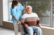 © Pixel-Shot - Smiling senior man in wheelchair and nurse at hospital
