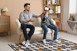 © Pixel-Shot - Father and his little son in VR glasses having fun at home
