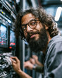 © Siriroj - Curly-haired man with glasses and beard smiles near server rack