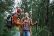 © LIGHTFIELD STUDIOS - Couple enjoying a colorful autumn forest with trekking poles