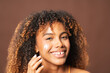 © Gonzalo Infiesta - Happy woman applying facial cream for glowing skin