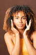© Gonzalo Infiesta - Young woman applying face cream for skincare routine