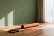 © Harris - Yoga mat and sandals on wooden floor by window
