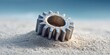© No PEOPLe - metallic gear on sandy beach with frosted edges in bright sunlight