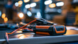 © Laura - portable jump starter displayed on a bright workshop bench for emergency vehicle battery support, roadside assistance concept, automotive equipment, travel safety, mechanical
