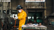 © chokniti - Welder worker helmet mask glove yellow jacket torch workshop metal worker preparing welding torch in industrial interior with focused expression