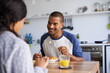 © peopleimages.com - Man, smile and couple at dining table with breakfast, relax and bonding together on peaceful weekend. People, dating and morning in home with food, drink or romantic connection for happy relationship
