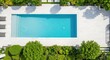 © PHOUVONG  - High angle aerial view of a luxury backyard featuring a crystal clear rectangular swimming pool surrounded by stone tiles and lush garden, summer, real, estate