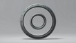 © Didin - Isolated metallic bearing ring on gray background.