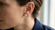 © Rosid - Woman's ear wearing sparkling diamond stud earrings, elegant jewelry close-up
