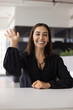 © fizkes - Profile picture of smiling Arabian young 35s woman start video call seated in modern office, greeting corporate client, finalize remote negotiations. Virtual meeting event, digital communication, tech