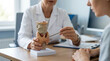 © Jesica - Doctor Explains Thyroid Anatomy Model to Patient