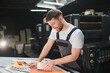 © Serhii - Print worker checking color quality on paper