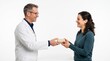 © gabriel - Doctor in white coat hands small package to smiling woman in blue sweater against white background