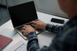 © Tj - Man's hands typing on a laptop computer, working from home or office, focusing on remote work, online learning, digital communication, and internet technology