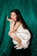 © Tania Cervian/Stocksy - Young woman crouching with classic elegant style