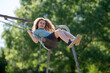 © Volodymyr - Child swinging creates summer happiness. Happy child enjoys playground motion. Child play feels carefree outdoors. Child mood looks joyful and sunny.