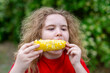 © Volodymyr - Cute kid enjoys tasty corn cob. Cute child smiles with summer snack. Outdoor portrait shows cute childhood joy. Healthy food makes cute lifestyle image.