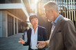 © Davor - Two business colleagues discussing strategy outside city office