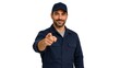 © Andrii  - Friendly Professional Worker Pointing at Camera Isolated on White Background